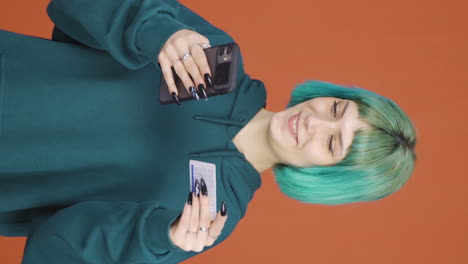 Vertical-video-of-Young-woman-shopping-on-the-phone.